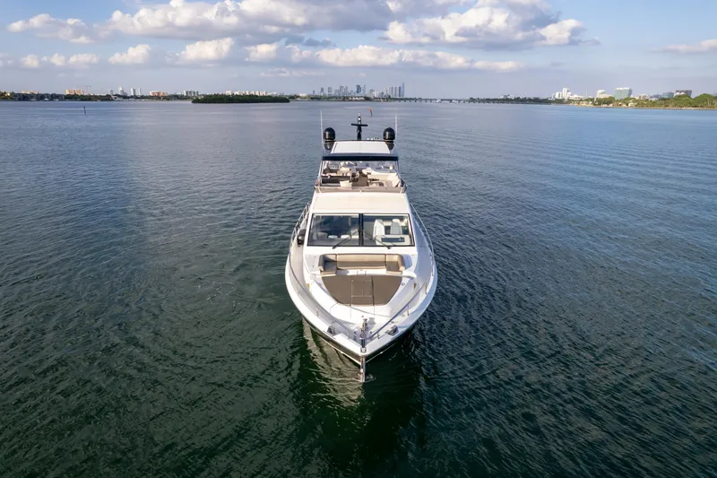  Yacht Photos Pics Luxurious 2020 Pearl 80 yacht cruising on calm waters under a partly cloudy sky.