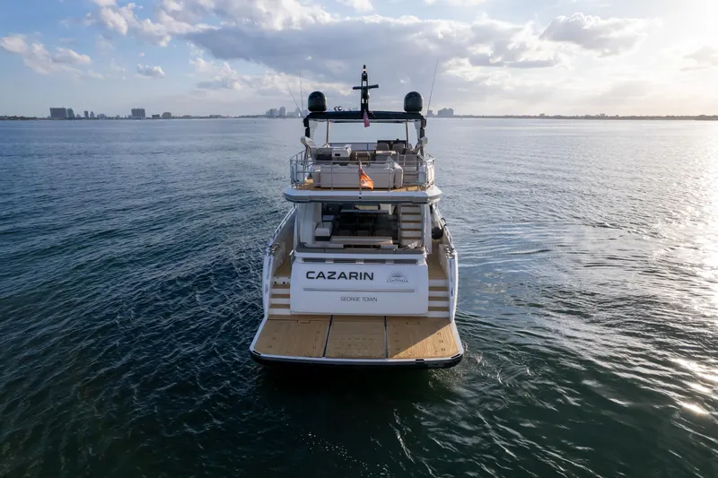  Yacht Photos Pics Luxury Pearl 80 yacht on open water, 2020 model, with city skyline in background.