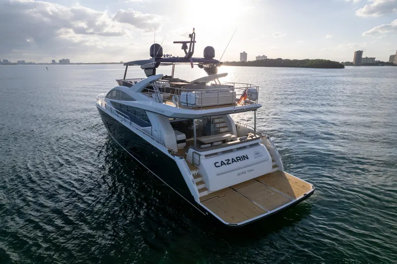  Yacht Photos Pics Luxurious 2020 Pearl 80 yacht cruising on serene waters at sunset.