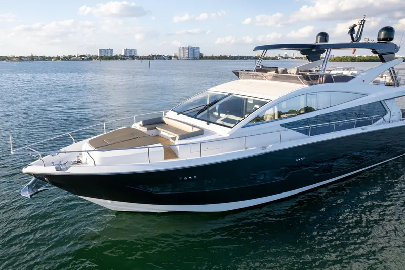  Yacht Photos Pics Luxurious 2020 Pearl 80 yacht cruising on serene waters under a partly cloudy sky.