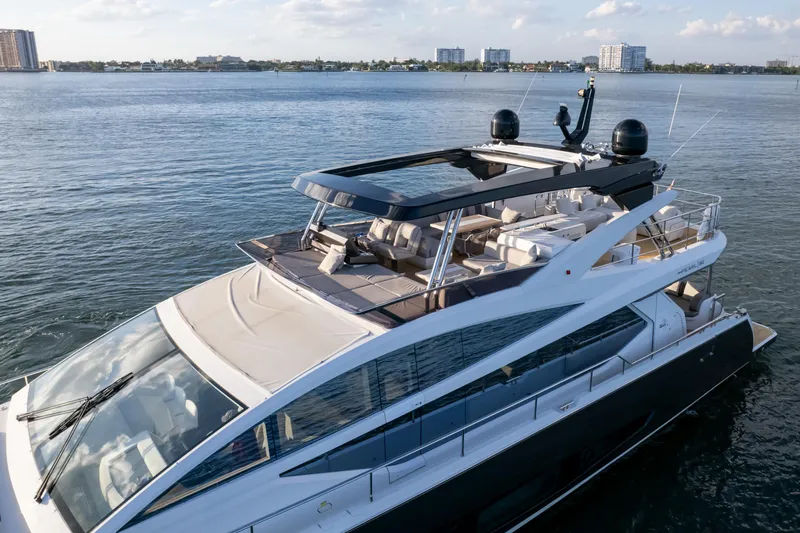  Yacht Photos Pics Luxurious 2020 Pearl 80 yacht cruising on calm waters under a clear sky.