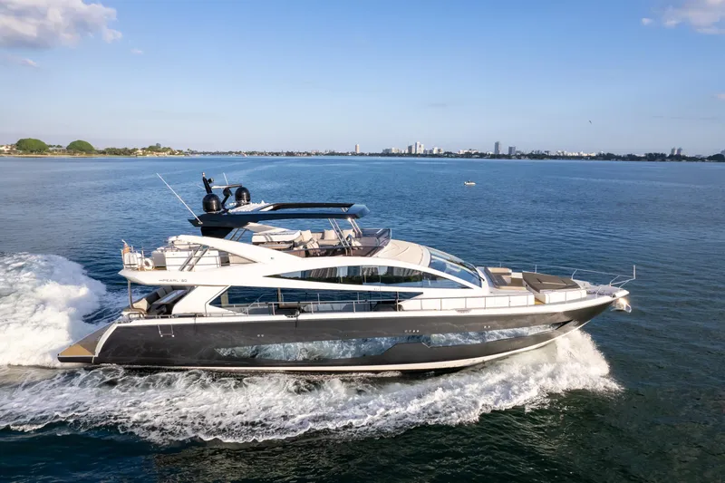  Yacht Photos Pics Luxurious 2020 Pearl 80 yacht cruising on open water under clear blue skies.