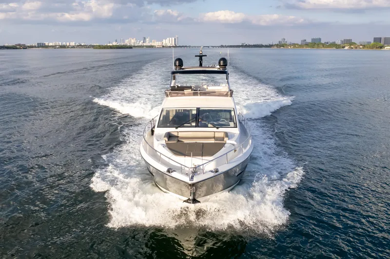  Yacht Photos Pics Luxurious 2020 Pearl 80 yacht cruising on open water under a partly cloudy sky.
