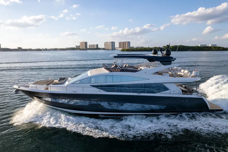  Yacht Photos Pics Luxurious 2020 Pearl 80 yacht cruising on open water under a clear blue sky.