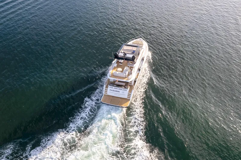  Yacht Photos Pics Aerial view of 2020 Pearl 80 yacht cruising on open water.
