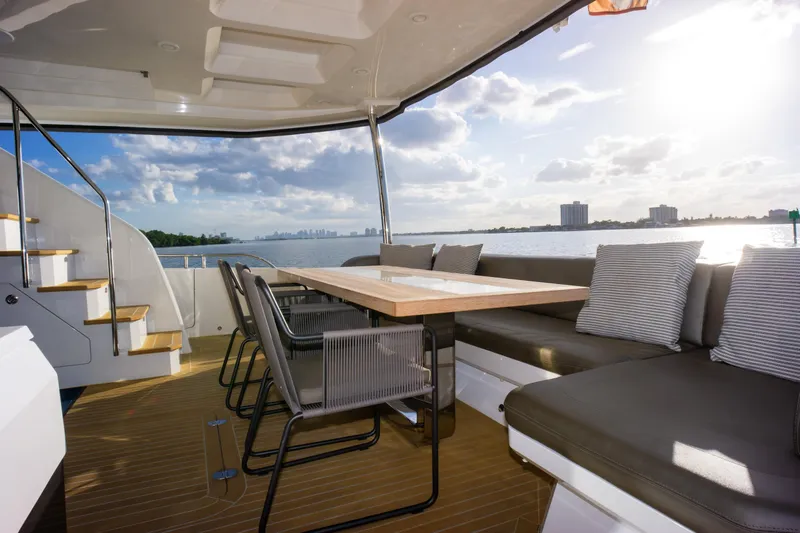  Yacht Photos Pics Luxurious Pearl 80 yacht deck with seating, table, and scenic ocean view, 2020 model.