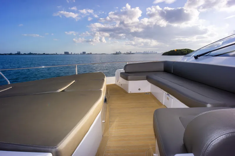  Yacht Photos Pics Luxurious Pearl 80 yacht deck with seating, overlooking serene ocean and skyline, 2020 model.