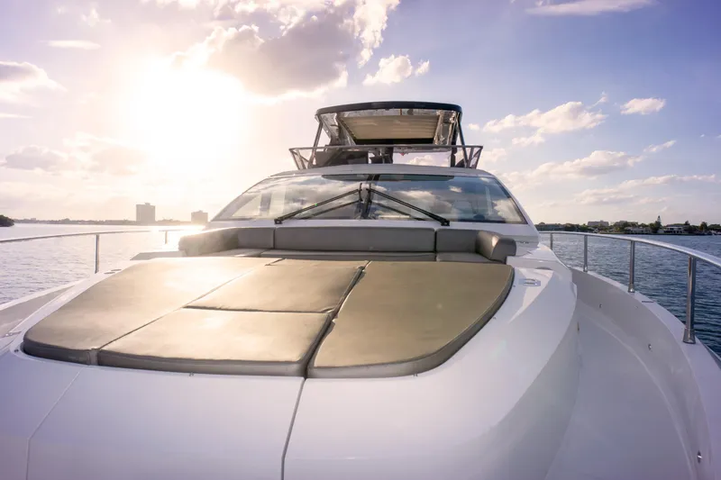  Yacht Photos Pics Luxurious 2020 Pearl 80 yacht on serene water at sunset.