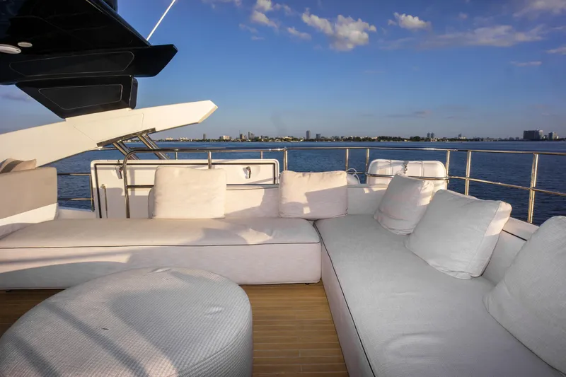  Yacht Photos Pics Luxurious Pearl 80 yacht deck with plush seating, overlooking serene ocean view.