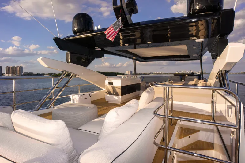  Yacht Photos Pics Luxurious 2020 Pearl 80 yacht deck with elegant seating and scenic ocean view.