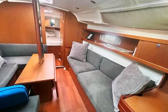 Namaste Yacht Photos Pics Interior of 2013 Beneteau Oceanis 37 yacht with cozy seating and wooden finishes.