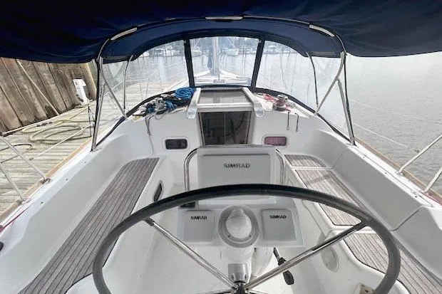 Namaste Yacht Photos Pics Cockpit view of 2013 Beneteau Oceanis 37 sailboat with steering wheel and navigation equipment.