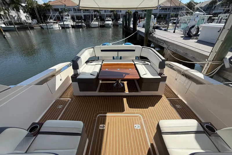  Yacht Photos Pics 2019 Tiara Sport 38 LS yacht with elegant seating and wooden deck at marina.
