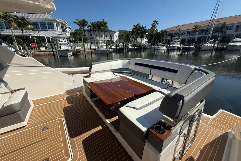  Yacht Photos Pics Luxury seating area on 2019 Tiara Sport 38 LS yacht, docked in a marina.