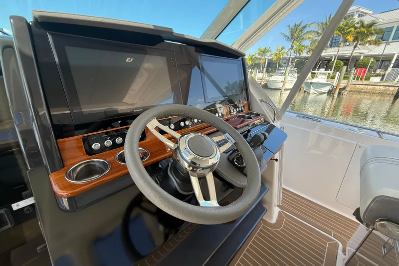  Yacht Photos Pics 2019 Tiara Sport 38 LS helm with modern controls and dual displays, dockside view.