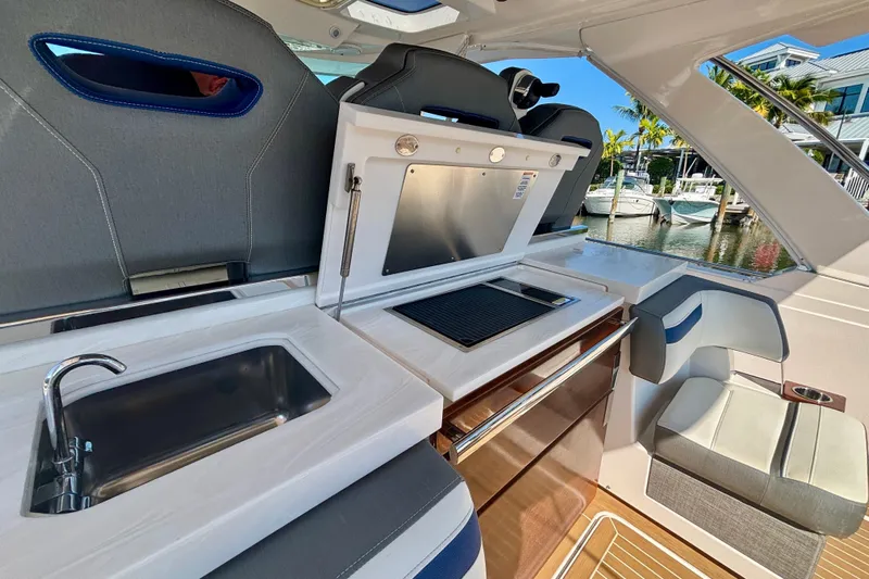  Yacht Photos Pics Luxurious 2019 Tiara Sport 38 LS yacht interior with kitchenette and seating area.