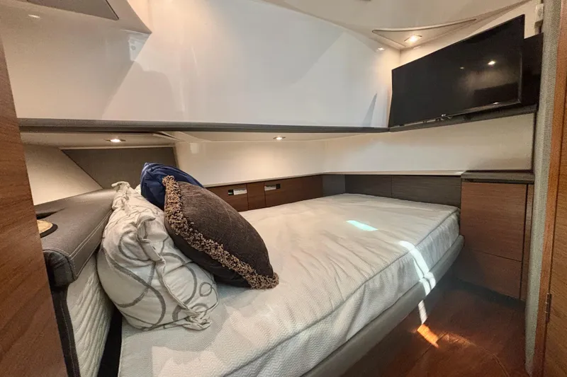  Yacht Photos Pics Luxurious cabin interior of 2019 Tiara Sport 38 LS with cozy bedding and TV.