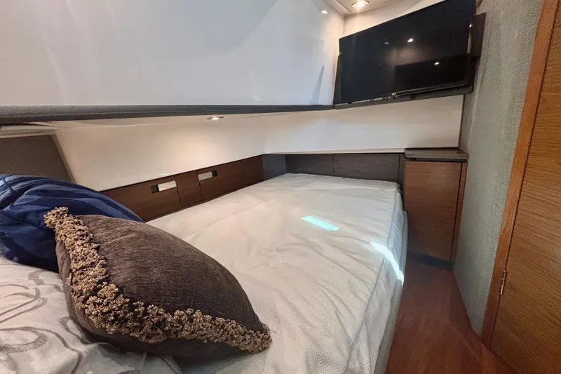  Yacht Photos Pics Luxurious cabin interior of 2019 Tiara Sport 38 LS yacht with bed and TV.