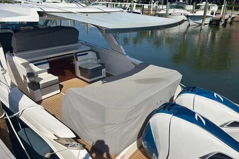  Yacht Photos Pics 2019 Tiara Sport 38 LS yacht with covered seating and twin engines docked at marina.