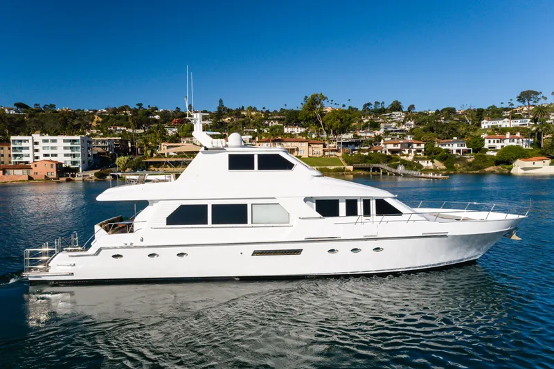 Rising Tide Yacht Photos Pics 1997 Forbes Cooper Pilothouse yacht cruising near scenic coastal homes.