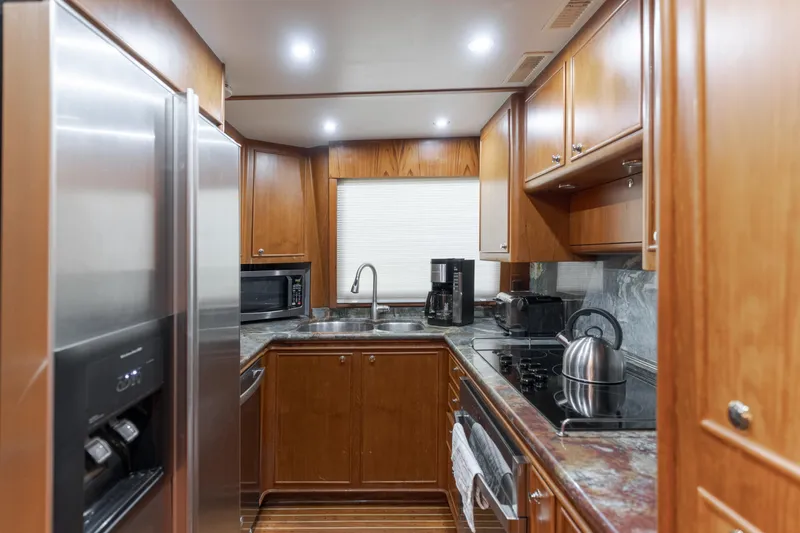 Rising Tide Yacht Photos Pics Luxurious 1997 Forbes Cooper Pilothouse kitchen with modern appliances and wooden cabinetry.
