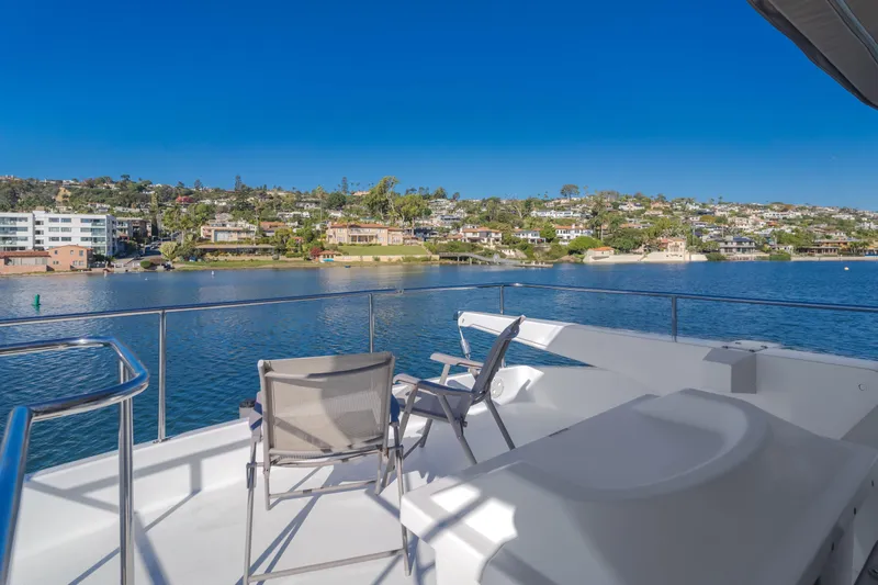 Rising Tide Yacht Photos Pics 1997 Forbes Cooper Pilothouse yacht deck with scenic waterfront view.