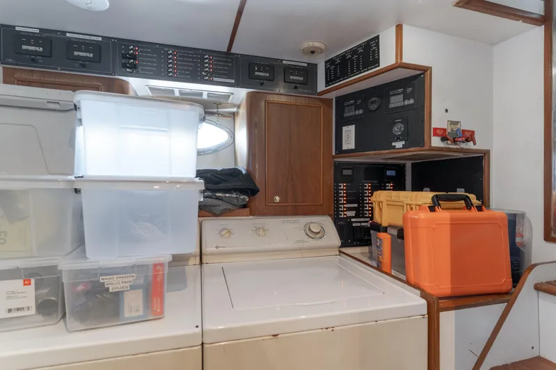 Rising Tide Yacht Photos Pics Laundry area on 1997 Forbes Cooper Pilothouse with storage boxes and control panels.