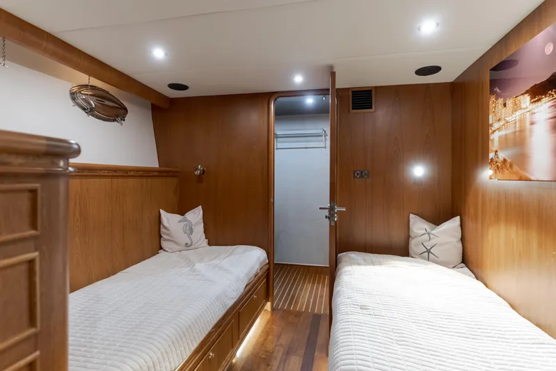 Rising Tide Yacht Photos Pics Luxurious 1997 Forbes Cooper Pilothouse cabin with twin beds and elegant wood paneling.