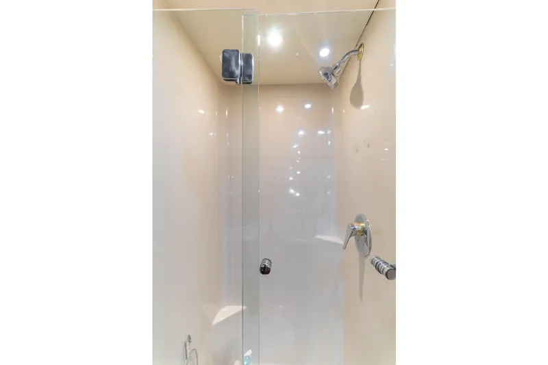 Rising Tide Yacht Photos Pics Shower area in 1997 Forbes Cooper Pilothouse yacht with glass door and chrome fixtures.