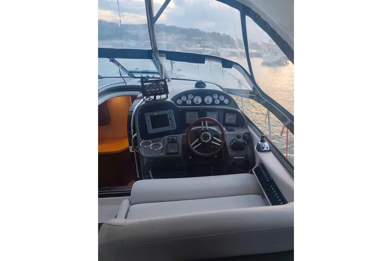 Yacht Photos Pics Interior cockpit of 2007 Regal Commodore 4060 yacht with steering wheel and navigation instruments.