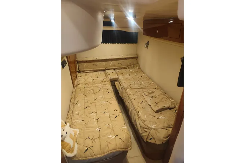  Yacht Photos Pics Cozy cabin interior of 2007 Regal Commodore 4060 with twin beds and warm lighting.
