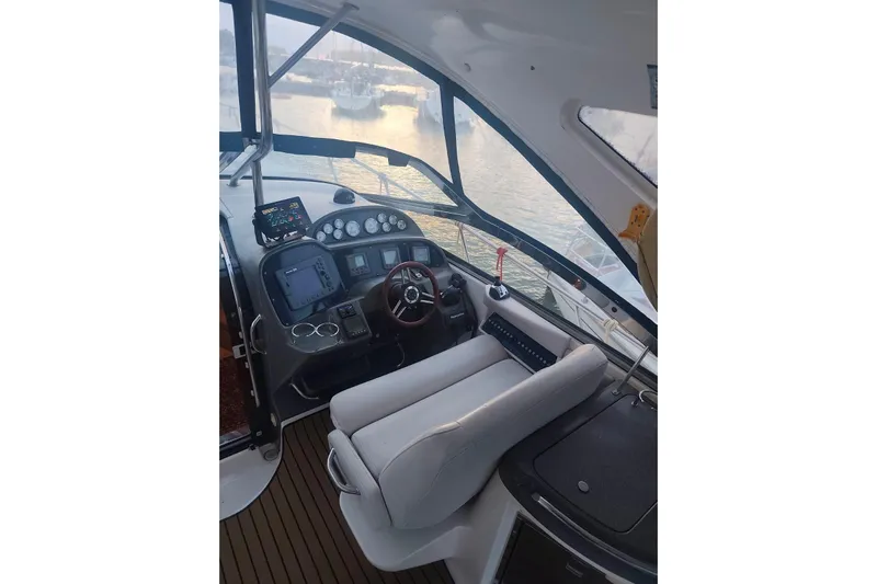  Yacht Photos Pics 2007 Regal Commodore 4060 boat cockpit with steering wheel and navigation controls.