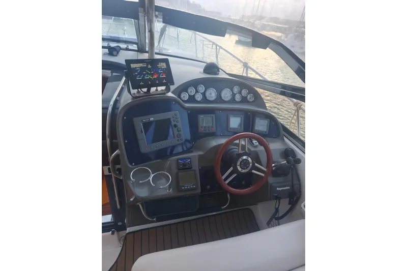  Yacht Photos Pics Helm of 2007 Regal Commodore 4060 yacht with navigation instruments and steering wheel.