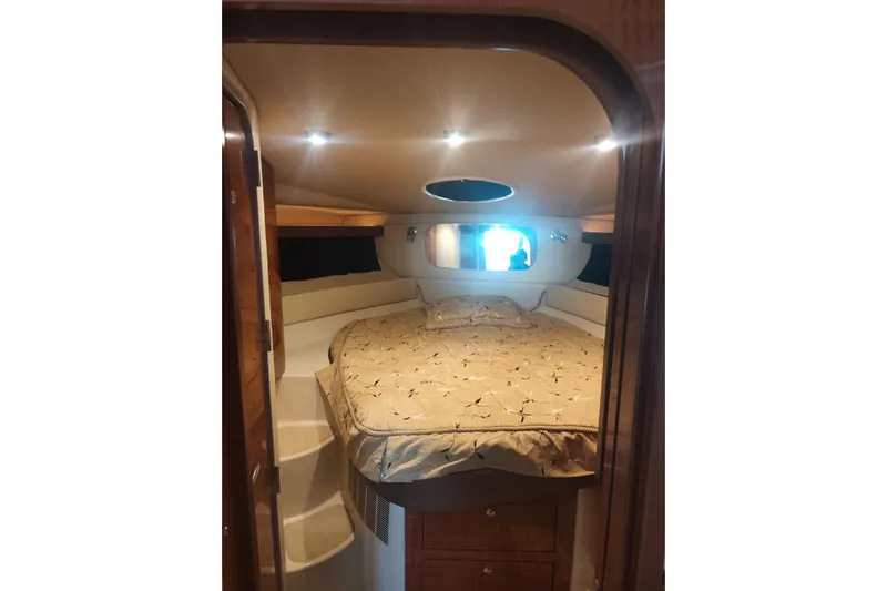  Yacht Photos Pics Luxurious cabin interior of 2007 Regal Commodore 4060 yacht with cozy bed and ambient lighting.