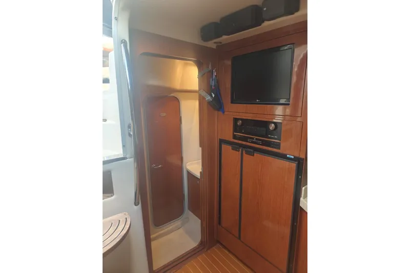  Yacht Photos Pics Interior of 2007 Regal Commodore 4060 yacht with wood paneling and entertainment system.