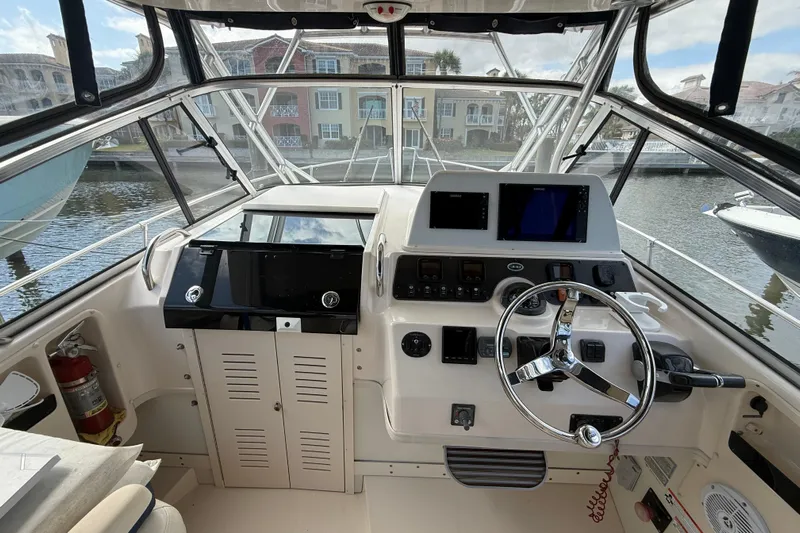  Yacht Photos Pics 2009 Grady-White Marlin 300 boat helm with steering wheel and navigation equipment.