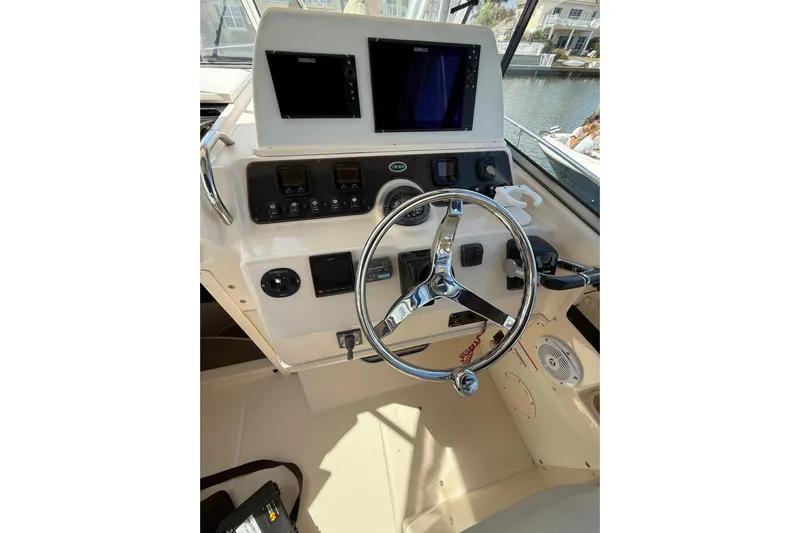  Yacht Photos Pics 2009 Grady-White Marlin 300 helm with dual Simrad displays and chrome steering wheel.