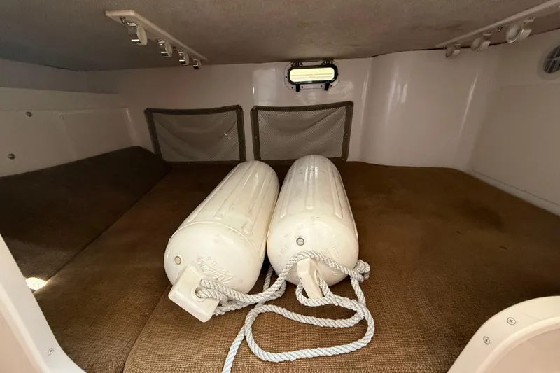  Yacht Photos Pics 2009 Grady-White Marlin 300 cabin interior with fenders and storage nets.