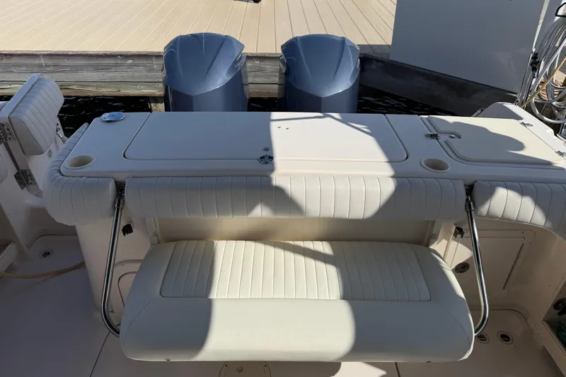 Yacht Photos Pics 2009 Grady-White Marlin 300 boat with dual engines and cushioned seating at the dock.