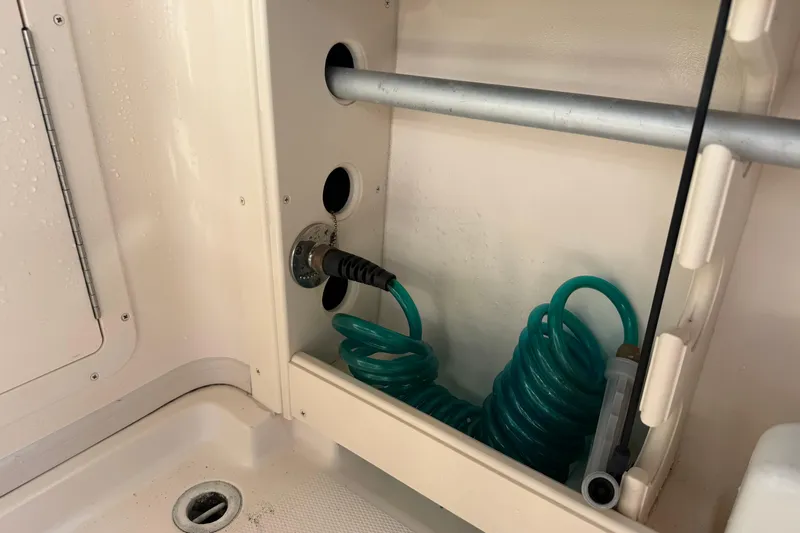  Yacht Photos Pics 2009 Grady-White Marlin 300 boat interior with coiled hose and storage compartment.