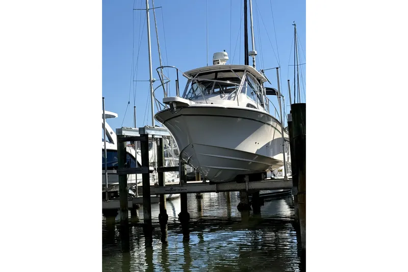  Yacht Photos Pics 2009 Grady-White Marlin 300 boat docked at a marina, viewed from the front.