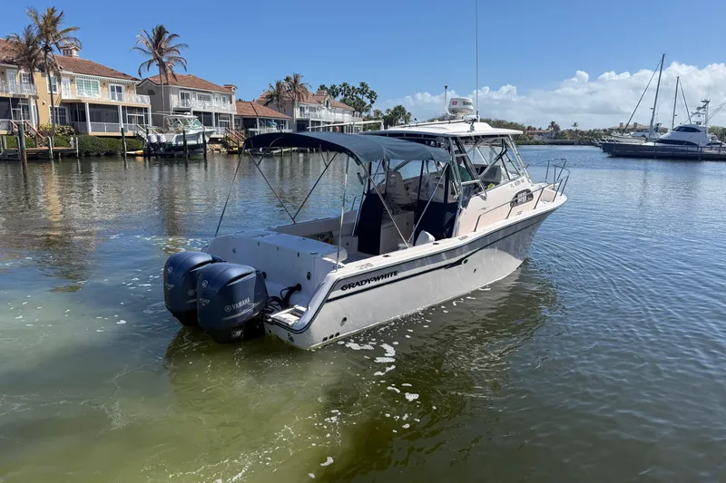  Yacht Photos Pics 2009 Grady-White Marlin 300 boat with twin Yamaha engines on a sunny waterfront.