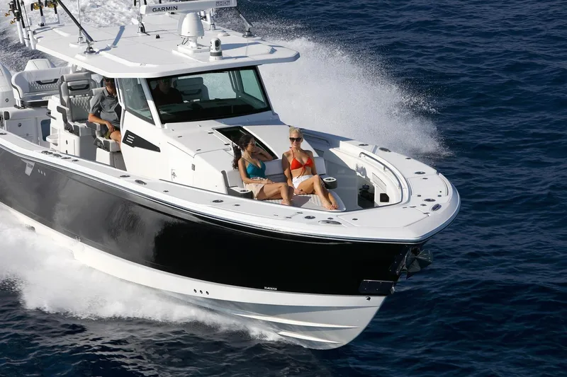  Yacht Photos Pics Manufacturer Provided Image: 2026 Blackfin 400 CC cruising on ocean with passengers enjoying the sun.
