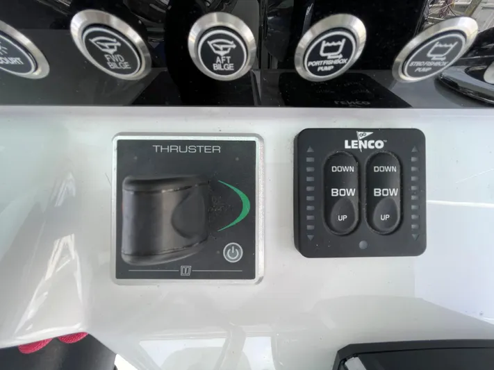  Yacht Photos Pics Control panel of a 2022 Bertram 39 CC boat with thruster and Lenco trim tabs.
