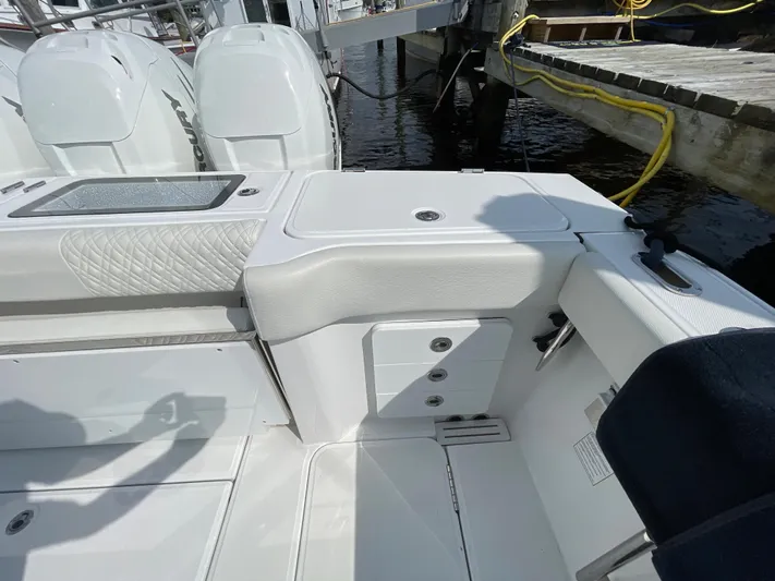  Yacht Photos Pics 2022 Bertram 39 CC boat interior with white seating and storage compartments.