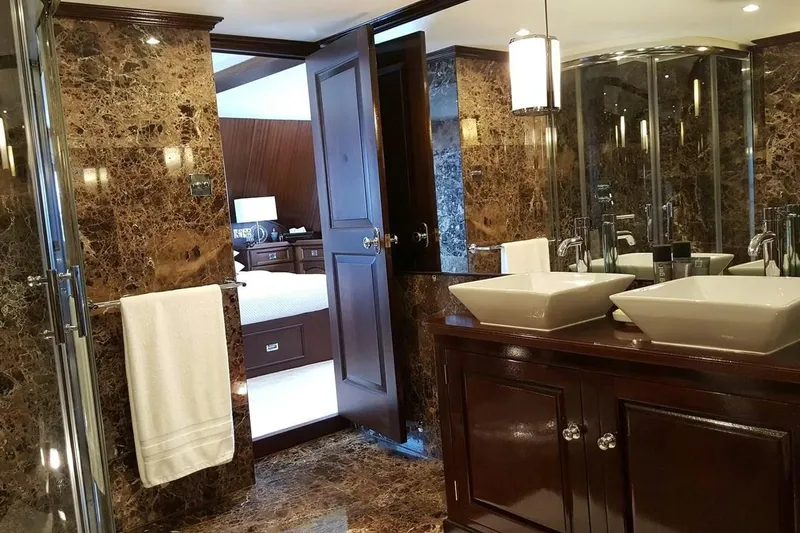  Yacht Photos Pics Luxurious 1975 Custom 39M yacht bathroom with marble decor and dual sinks.
