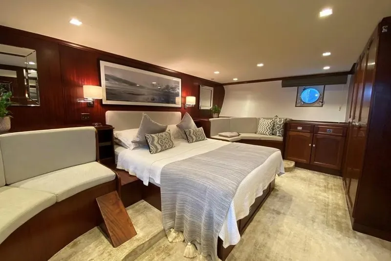  Yacht Photos Pics Luxurious 1975 Custom 39M yacht bedroom with elegant wood paneling and cozy seating area.