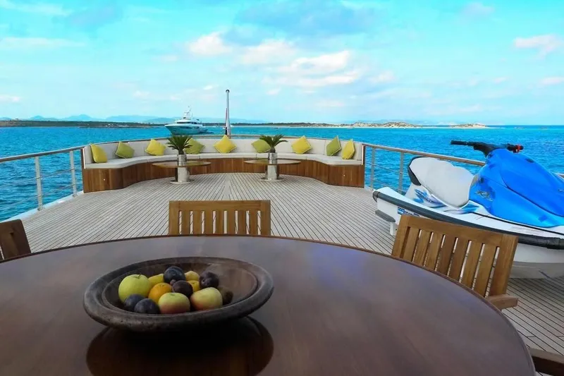 Yacht Photos Pics Luxurious 1975 Custom 39M yacht deck with seating, fruit bowl, and jet ski.