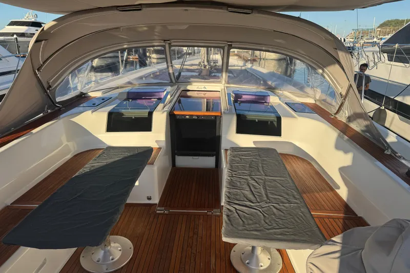  Yacht Photos Pics Spacious cockpit of 2013 Hanse 575 yacht with covered seating and wooden flooring.