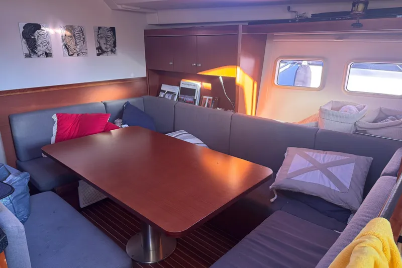  Yacht Photos Pics Interior of 2013 Hanse 575 yacht with cozy seating and wooden table.